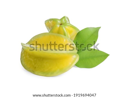 Ripe carambolas with green leaves on white background