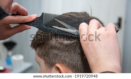 
Men's haircut. The barber cuts the man.  Royalty-Free Stock Photo #1919720948