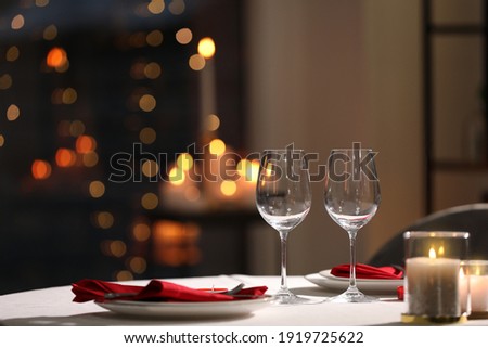 Table setting for romantic dinner in restaurant Royalty-Free Stock Photo #1919725622