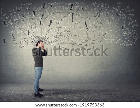 Side view full length of pensive and fatigue man suffers headache, pointing hands to temples. Guy has anxiety, mental health problems. Mess in head and pain feeling. Hard thinking, difficult task Royalty-Free Stock Photo #1919753363