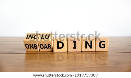 Onboarding and including symbol. Turned wooden cubes and changed the word 'onboarding' to 'including'. Beautiful white background, copy space. Business, onboarding and including concept.