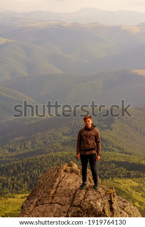 Young boy, tourist, portrait photos of a guy in the Carpathian mountains, picturesque and impressive Ukrainian Carpathians, view from the mountain Pip Ivan Chornohirsky.2020