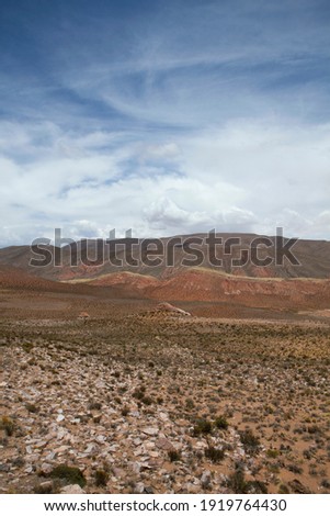 Arid desert background. The colorful canyon, arid valley, sandstone and rocky mountains under a beautiful sky.