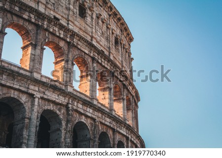 Coliseum (Colosseum), Rome, Italy. Ancient Roman Coliseum is famous landmark, top tourist attraction of Rome. Scenic view of Coliseum with blue sky. Sunny old Coliseum close-up in summer. Royalty-Free Stock Photo #1919770340