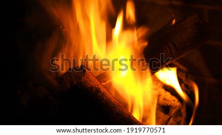 Slow shutter photo of fire in cosy fireplace