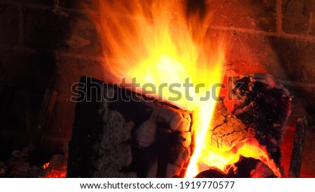 Slow shutter photo of fire in cosy fireplace