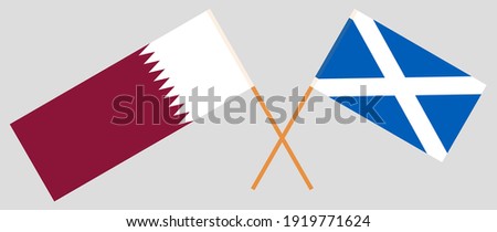 Crossed flags of Qatar and Scotland