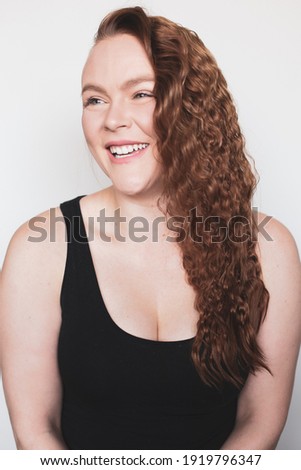 Portraits of a red headed woman with blue eyes against a white background in Arlington, Virginia.