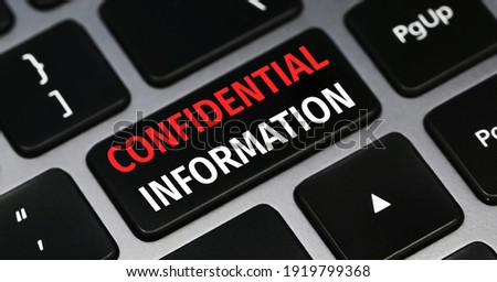 Confidential information text on a keyboard. Technology and business concept. Royalty-Free Stock Photo #1919799368