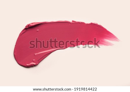Lipstick abstract strokes smudge  background texture mulberry plum colored on beige background