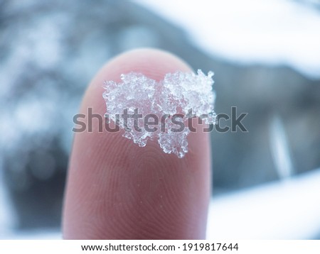 light closeup shot of snow melting on the fingertip 