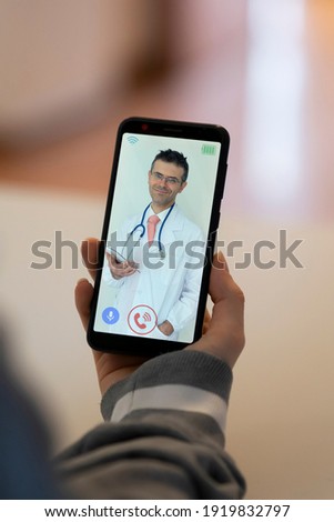 Woman receives medical consultation via smartphone. concept of telemedicine and remote visit via mobile phone.