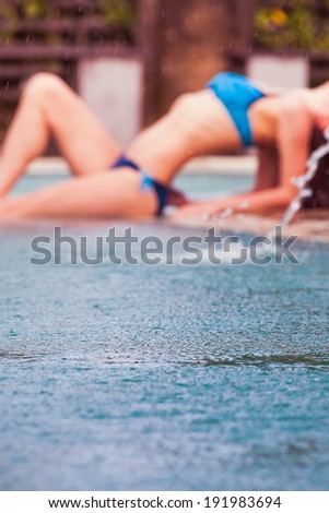 Woman relaxing at the pool near water, spa at Bali