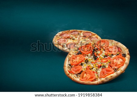 Floating, smoking pizzas on a turquoise background