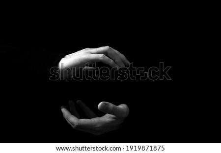 Male hands on a black background. Hands concept. Dark. 
