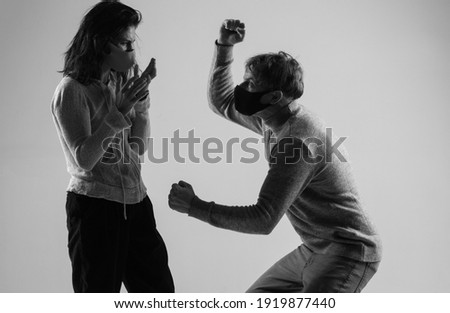 The attractive angry couple fighting and shouting at each other. quarrel concept.