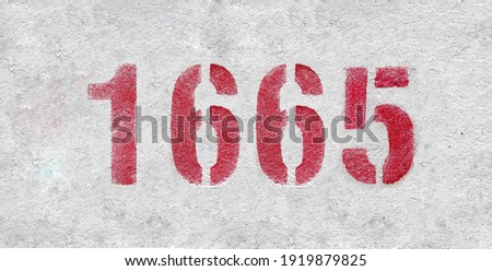 Red Number 1665 on the white wall. Spray paint.