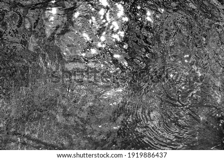 Black and white photo of Beautiful water texture. River in motion. Water natural background.