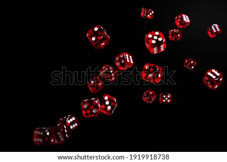 Many red dice flying on black background. Gambling concept. Royalty-Free Stock Photo #1919918738