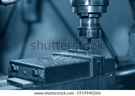 The NC milling machine drilling  at the metal part by flat drill tools. The shop floor operation by NC milling machine. Royalty-Free Stock Photo #1919940266