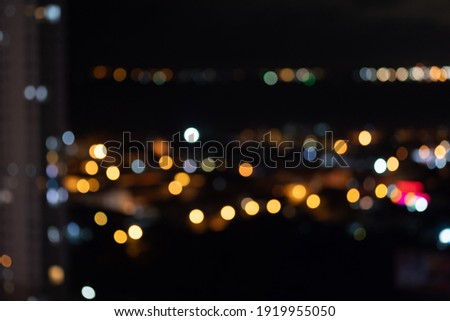 Blurred background of cityscape at night time, view from above