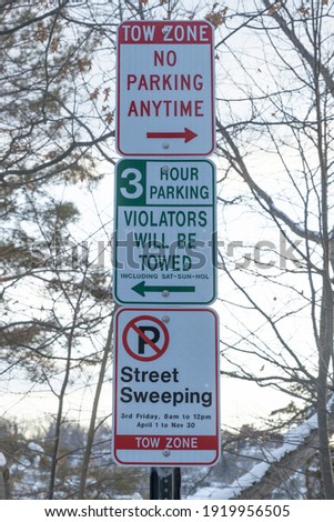 set of parking signs on top of each other