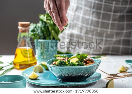 Green vegetable vegan salad with spinach, mushrooms and broccoli and quinoa. Healthy vegetarian food concept. top view. Royalty-Free Stock Photo #1919998358