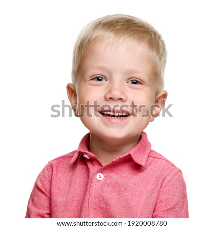 A 5-year-old boy with blond hair in a pink shirt laughs. isolated on a white background. A happy child. Baby teeth.