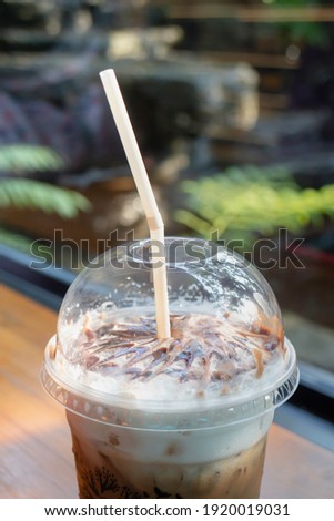 Latte coffee art cup in the garden, stock photo