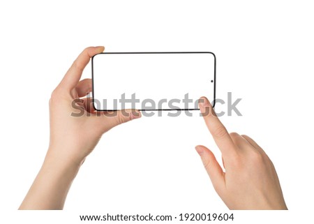 Cropped close up view photo picture of female woman's hands holding telephone in horizontal position touching screen isolated white backdrop Royalty-Free Stock Photo #1920019604