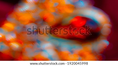 Blurred image of light from colored stones. Passers-by on the city street at night. Blurred background. Design element. Book cover. Social networks. Web design. Announcement.