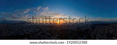 Sunset over Athens, Greece. Aerial drone panoramic view from Penteli mount. Last sunbeams over Greek capital background. Destination Athens, where sunrays caress, heat up people and hearts, banner.