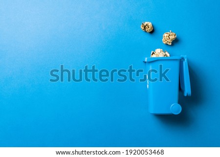 Recycling icon. Bin container for disposal garbage waste and save environment. Blue dustbin for recycle paper trash isolated on blue background