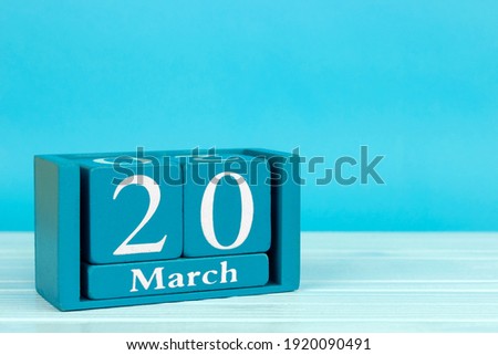 wooden calendar with the date of 
March 20 on a blue wooden background, 
World Sparrow Day; International Day of the French Language; World Narrative Day; World Head Injury Awareness Day;  