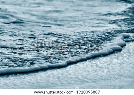 Soft wave on sandy beach. Background.concept for summer season. monochrome effect. soft and grain image.