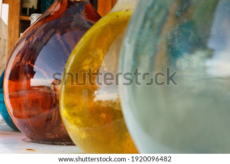 Reflections on big coloured glass jars