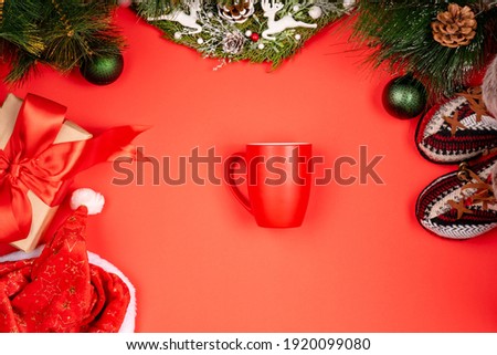Minimalistic stylish background for design free space on a red background Christmas and New Year wreaths and toys, cup