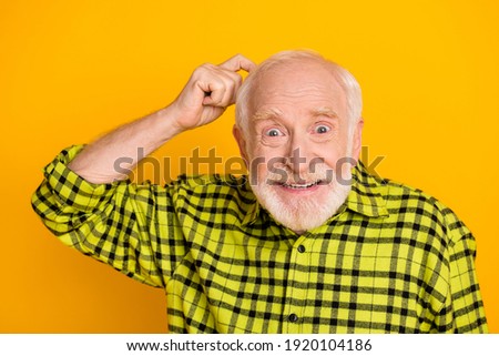 Photo of aged man pensioner finger touch head forget memory think isolated over yellow color background