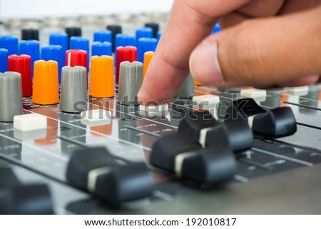 Hand making push button on an audio soundboard