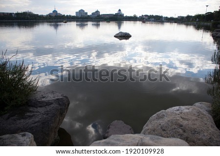Beautiful clouds reflected on the small artificial lake. This photo was taken on Oct 2 2014.