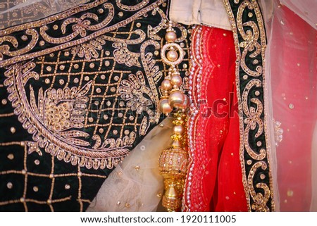 close up of stone studded tussles from a lehenga with intricate embroidery works Royalty-Free Stock Photo #1920111005