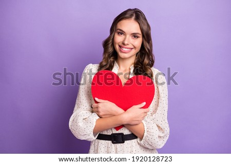 Photo portrait of woman embracing heart red postcard on date smiling isolated on pastel purple color background