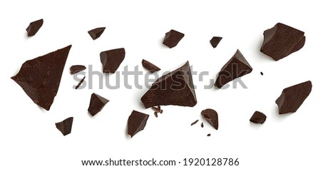 Cracked broken chocolates, chocolate chips morsels or chocolate parts from top view isolated on white background Royalty-Free Stock Photo #1920128786