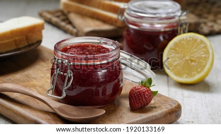 Strawberry jam is made from strawberries, sugar, and lemon juice that is cooked until thickened. This jam can be used for spreading white bread, filling cakes, etc. Royalty-Free Stock Photo #1920133169