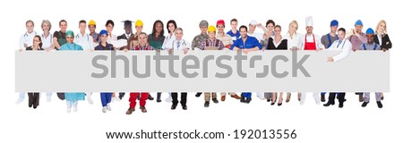 People with various occupations holding blank billboard against white background
