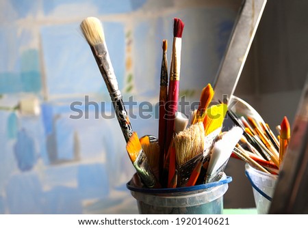 Art studio class painting brushes close up on blue abstract background. Brushes. Artist's workshop, artist's tools. Specially blurred. Royalty-Free Stock Photo #1920140621