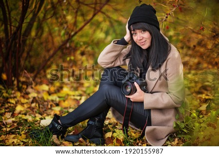 beautiful girl photographer in autumn park