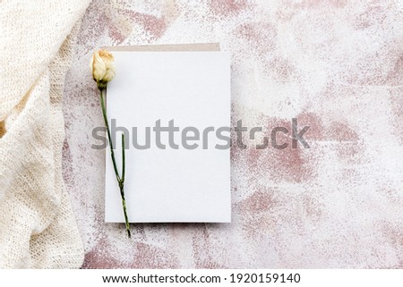 Romantic natural gentle background-a clean postcard and twigs of dry grass and flowers. Top view, close-up, and copy space. Wedding and gift fund.