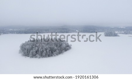 An aerial shot of snow-covered mountains on a winter day