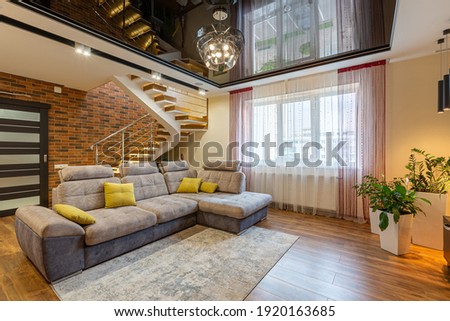 large living room, in a modern luxury style, with large windows and other furniture